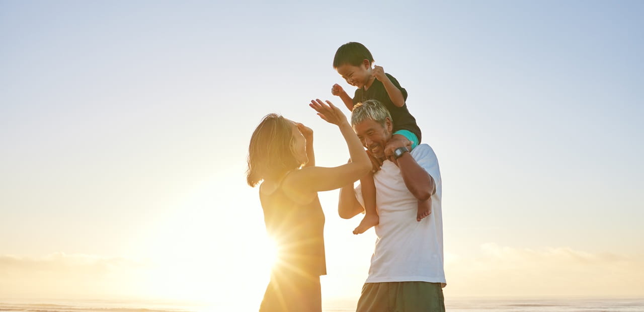 Family enjoying time together on the beach, reflecting the multigenerational planning and legacy-building benefits of 529 savings accounts beyond college funding.
