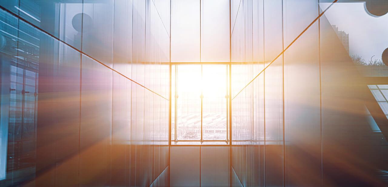 Sunlight flooding a modern glass atrium, symbolizing a sudden wealth event and the needed for thoughtful legacy planning.