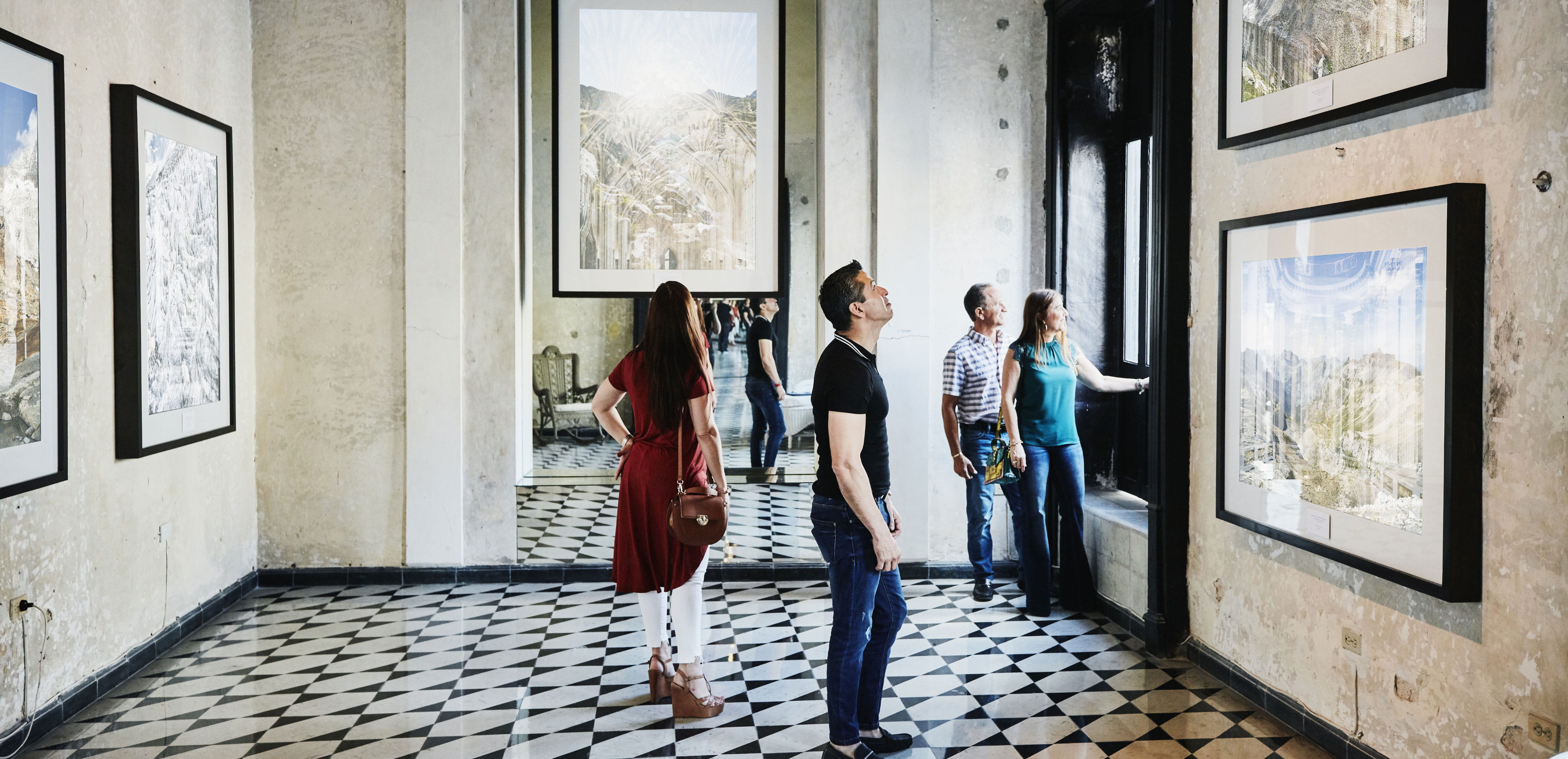 Visitors explore an art gallery, reflecting how charitable giving helps preserve arts, culture and community access.