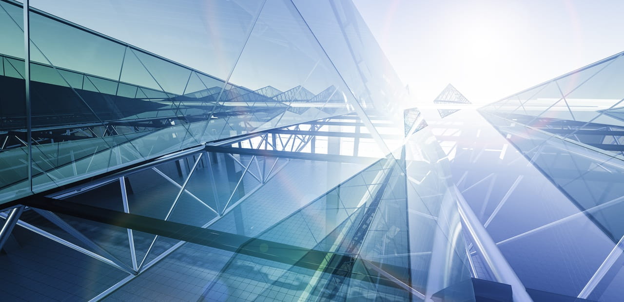 Modern glass buildings reflecting equity market resilience in a challenging macroeconomic environment.
