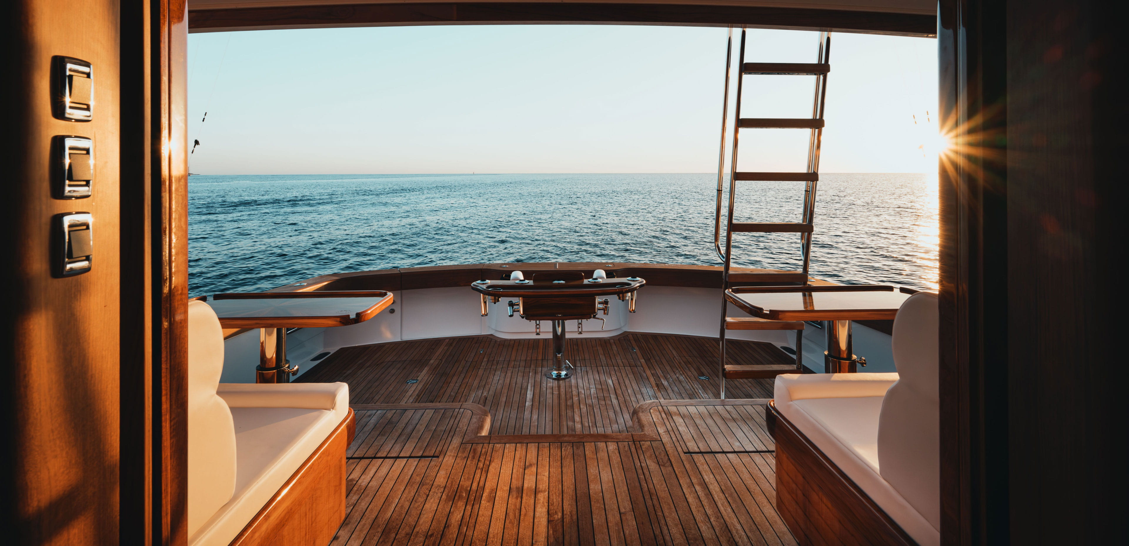 View from a chartered yacht overlooking calm open water at sunset, highlighting how yacht vacations are becoming more accessible for today's travelers seeking unique getaways.