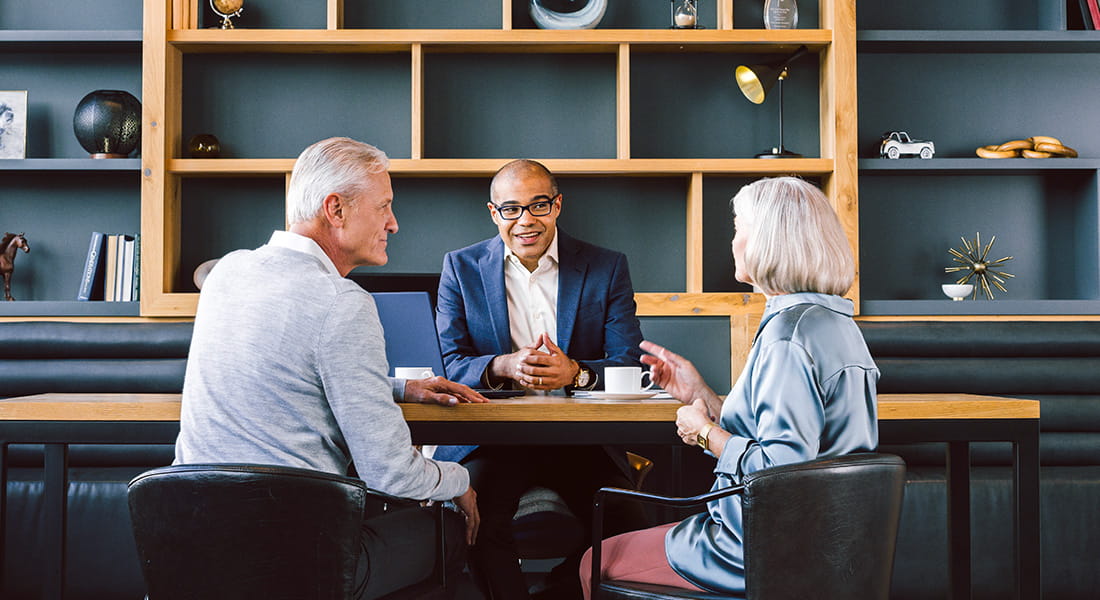 Advisor in meeting with mature clients