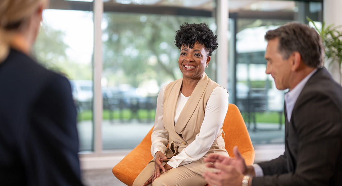 Smiling businesswoman with collegues