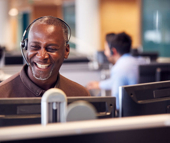 Mature Businessman Wearing Telephone Headset
