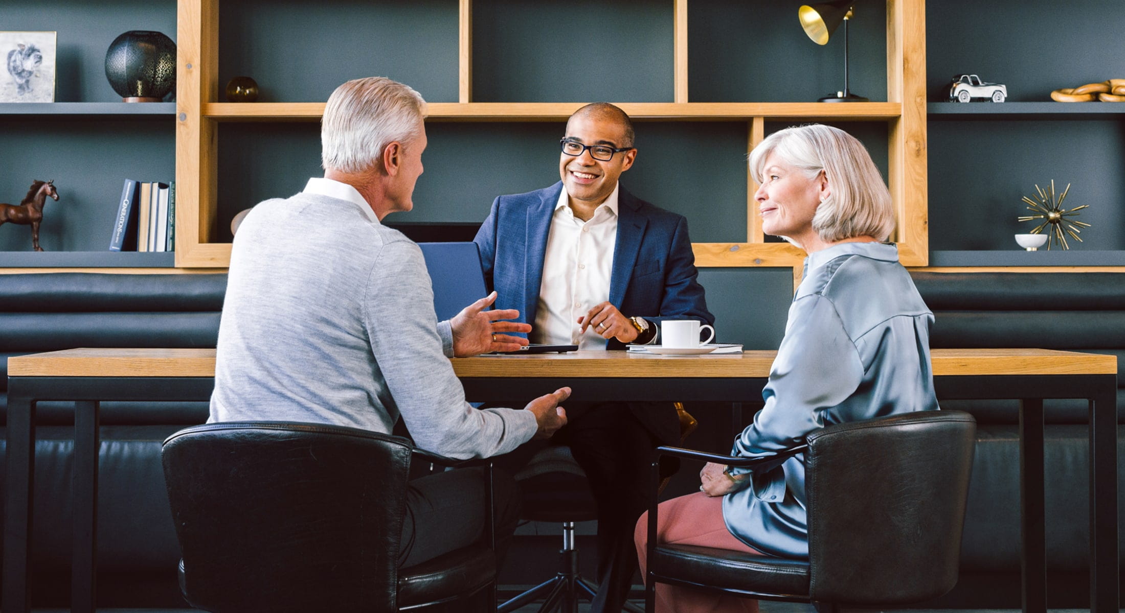 Financial advisor speaking with mature couple in office